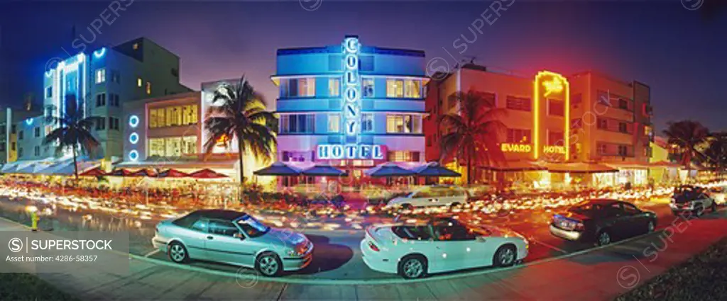 Glowing neon accents art deco era hotels along Ocean Drive at twilight, Miami Beach, Florida.