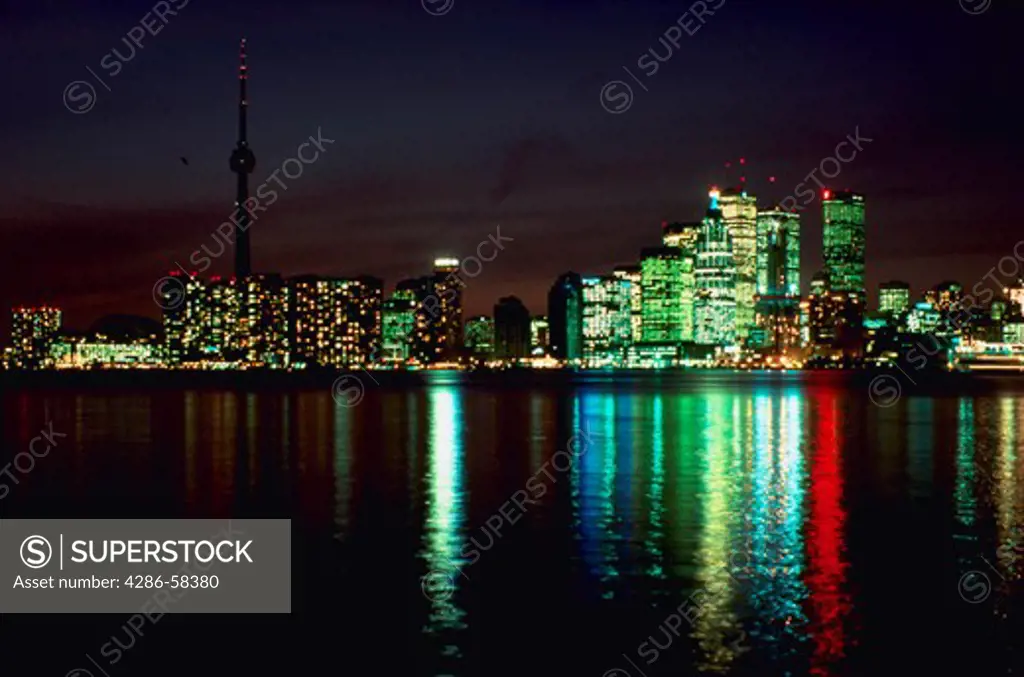 Night view of skyline reflecting in Lake Ontario harbour, Toronto, Ontario, Canada.