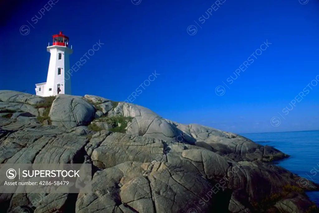 The red and white lighthouse that stands atop the rocks at Peggys Cove in New Brunswick.