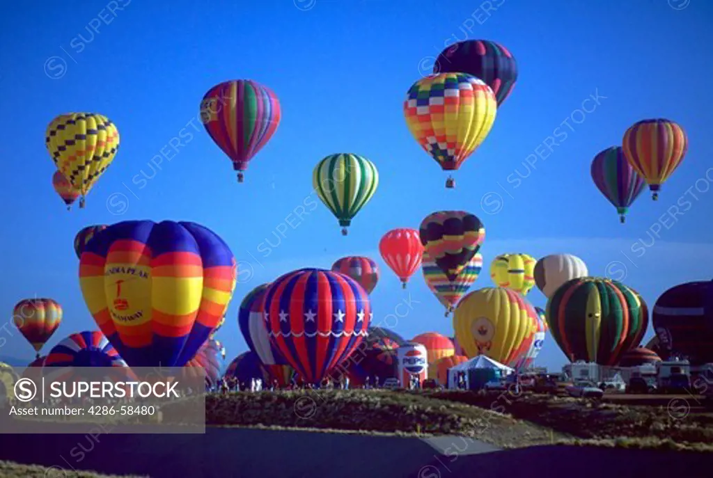 Several colorful hot air balloons being launched at the Albuquerque Balloon Festival in Albuquerque, New Mexico.