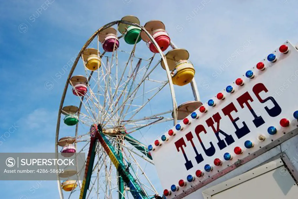 Ferris wheel next to a 'TICKETS' sign.