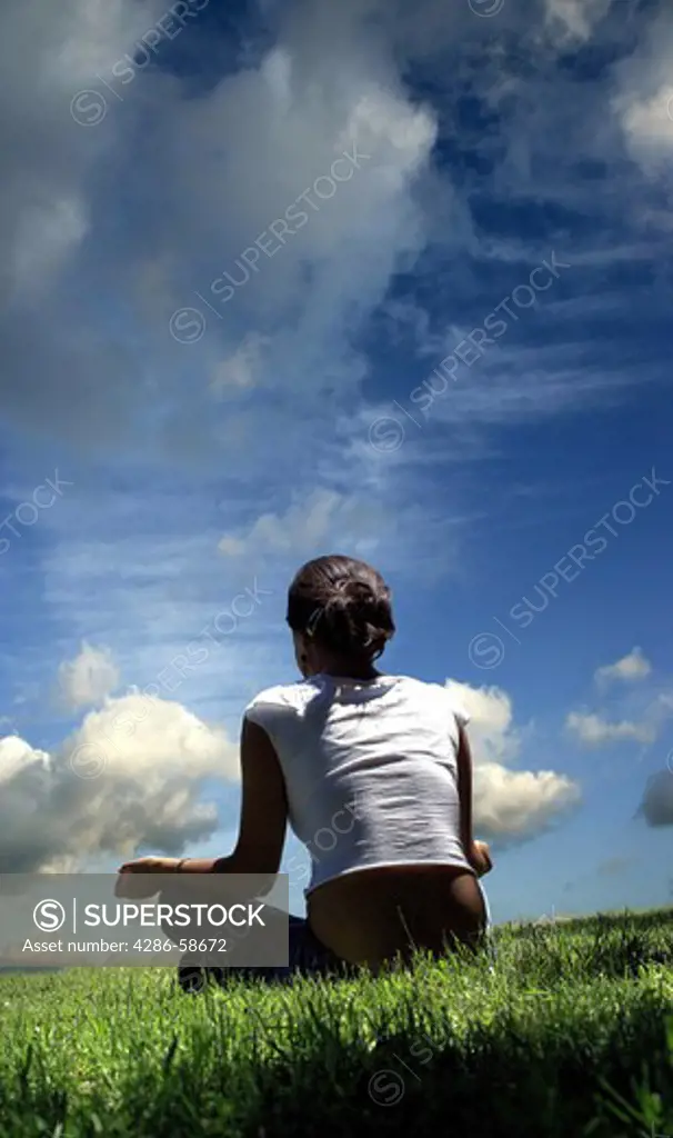 Woman meditating outdoors.