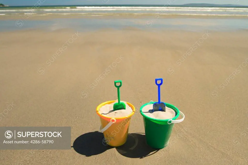 Sand pails on beach.