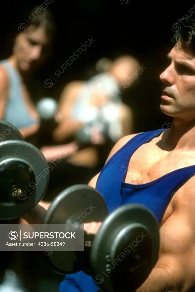 Man lifting weights at gym.