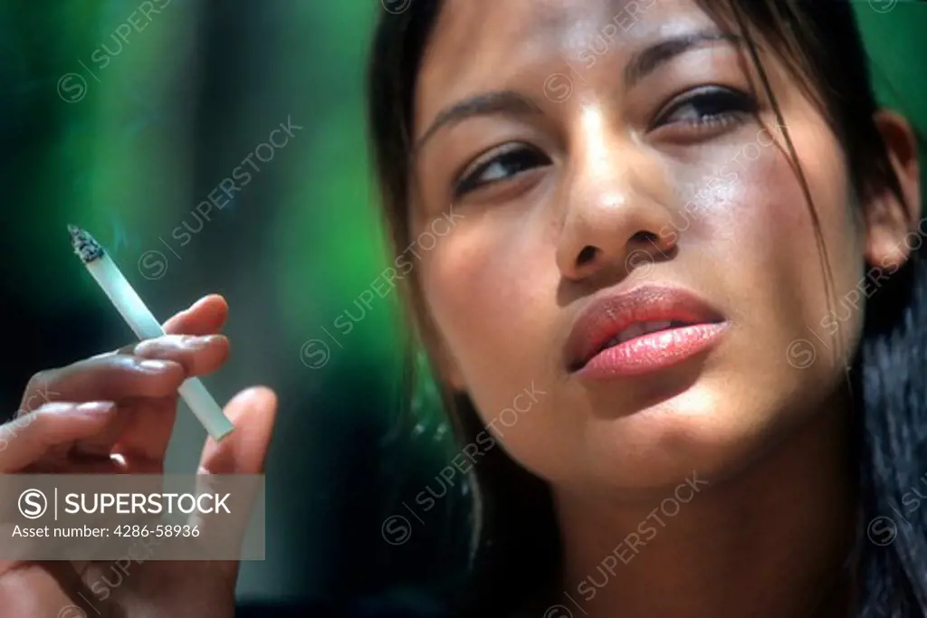 Latino woman smoking.