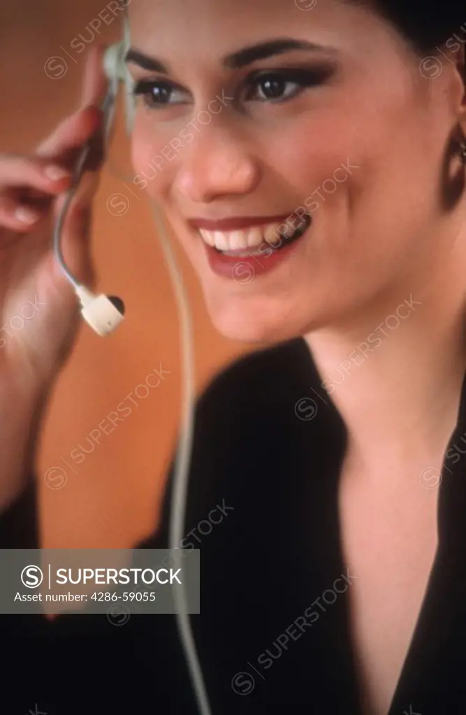 Latino business woman with telephone headset.