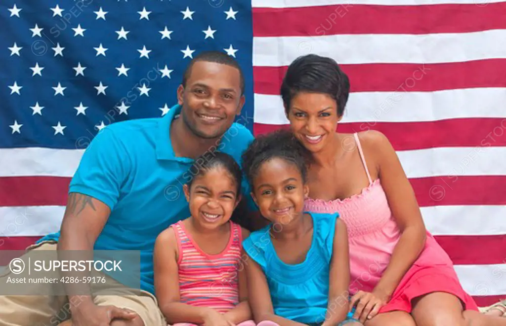 Black African American family loving the USA with flag and colors of holiday celebration