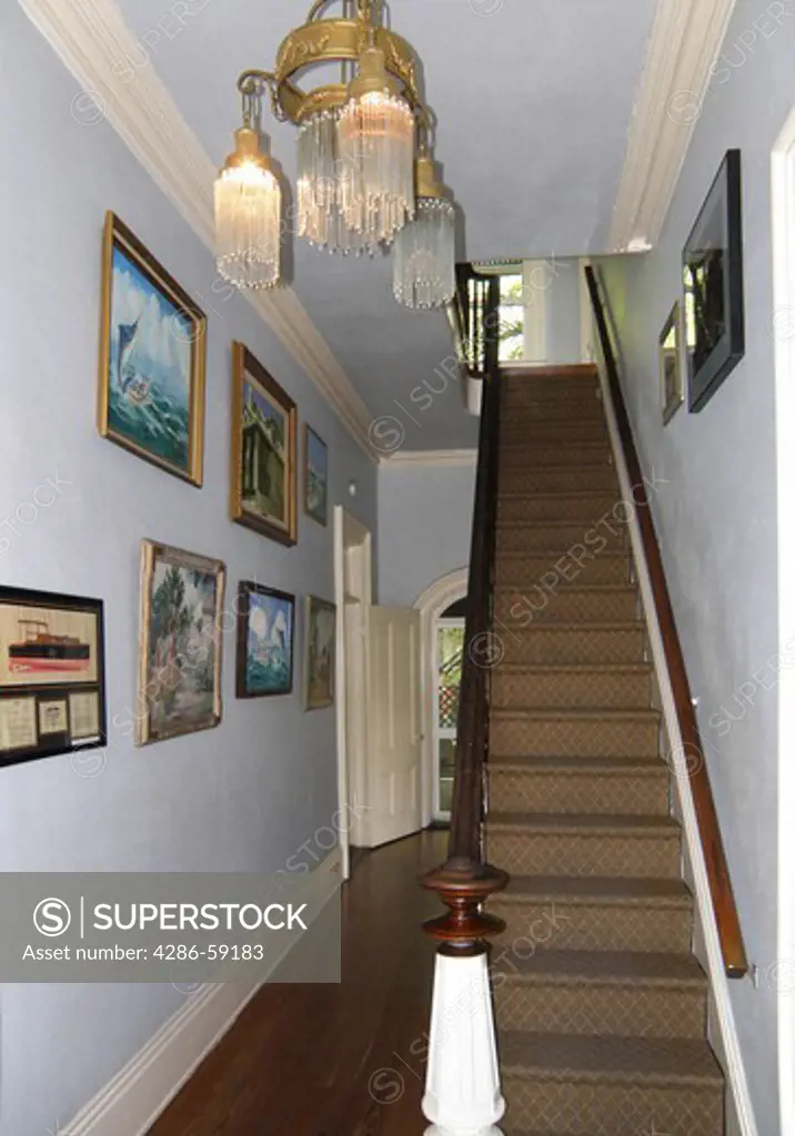 The main hallway and staircase in the Hemingway house, Key West, Florida.