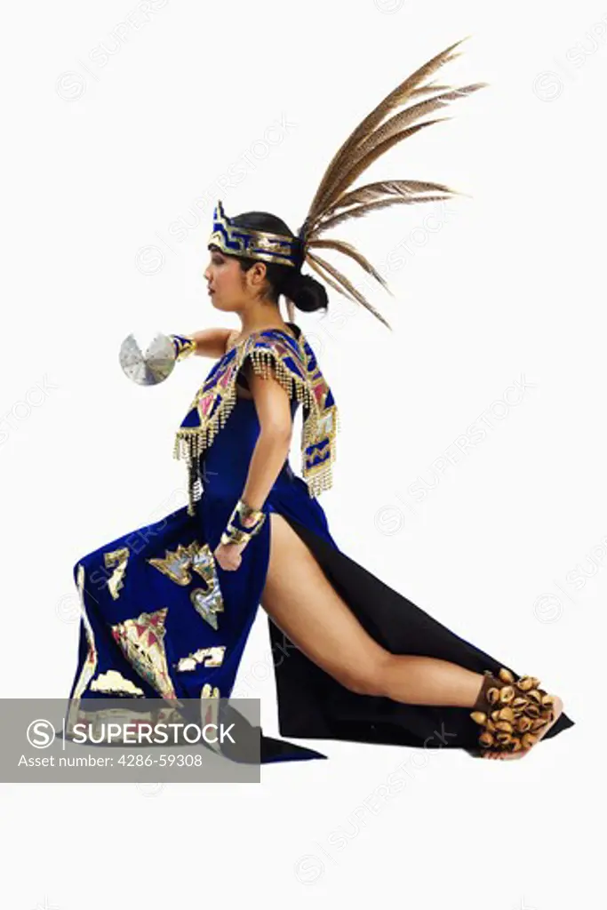 Side profile of an Aztec dancer wearing stage costume and performing