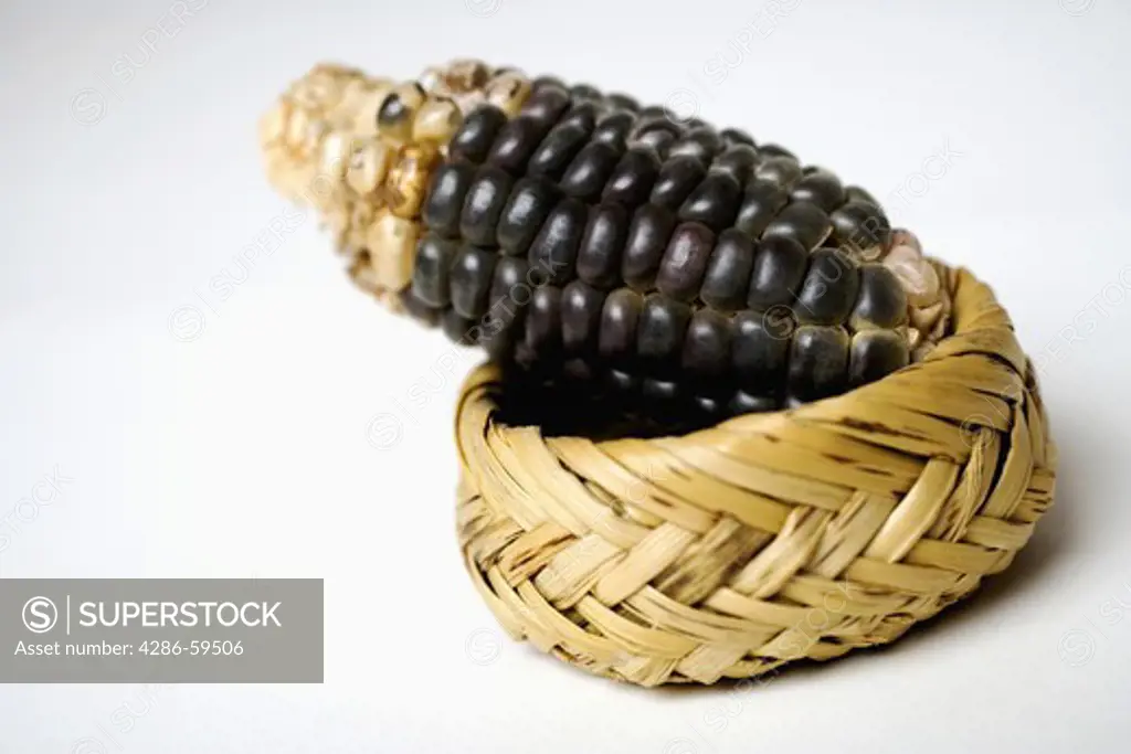 Close-up of a corn cob on a wicker basket