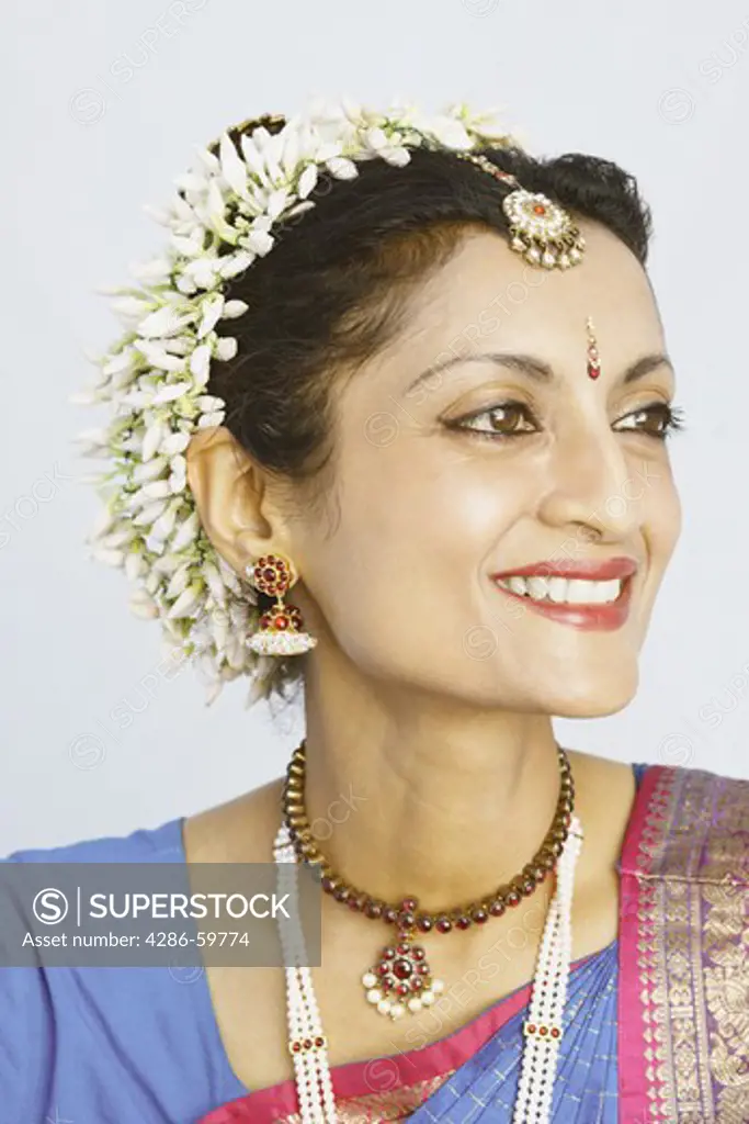 Close-up of a mature woman smiling in traditional clothing