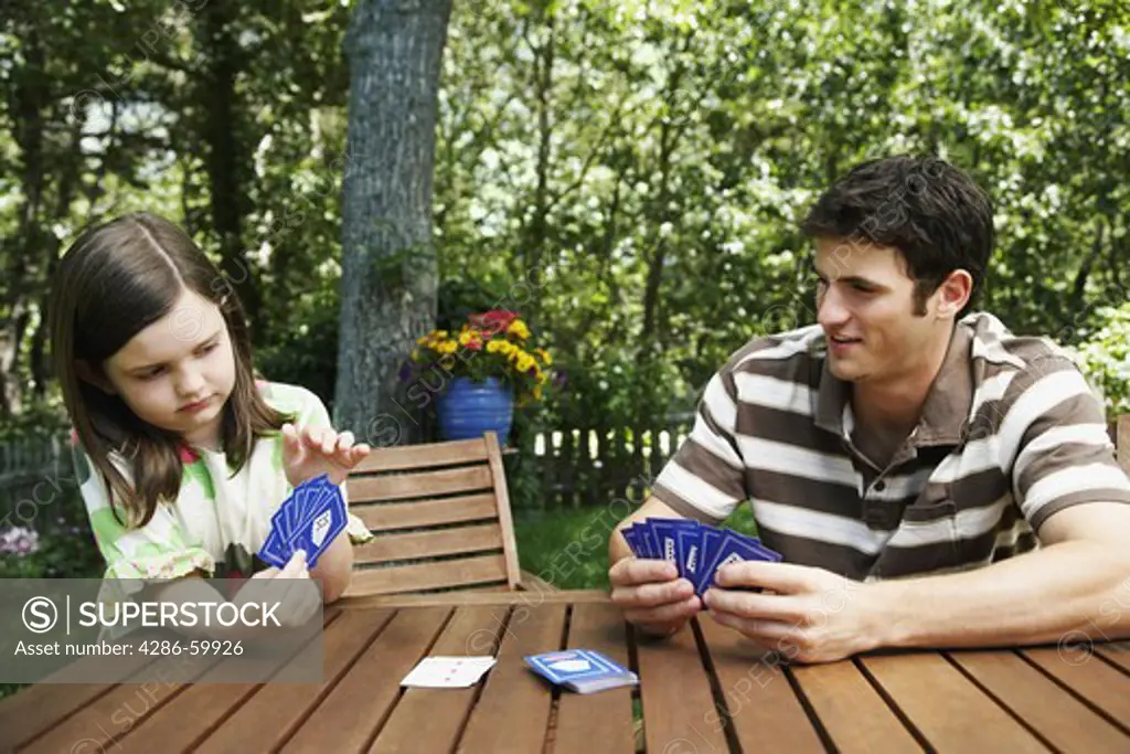 Young man with a girl playing cards
