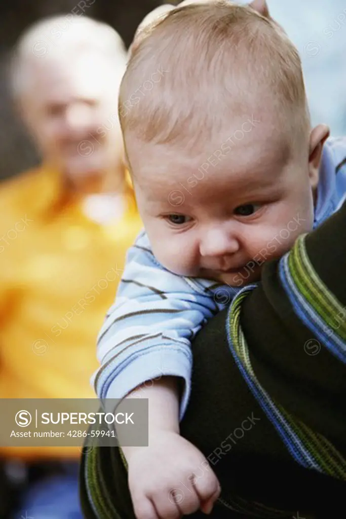 Close-up of a person carrying a baby