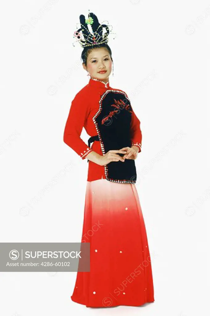Portrait of a teenage girl in traditional clothing and performing folk dance