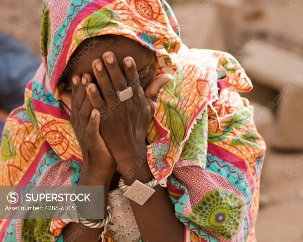 In Ouagadougou, Burkina Faso, Yuma Dicko, a young Fulani woman, covers her face in prayer.  More than half the population of this small, landlocked country is Muslim. NOT MODEL RELEASED. EDITORIAL USE ONLY.