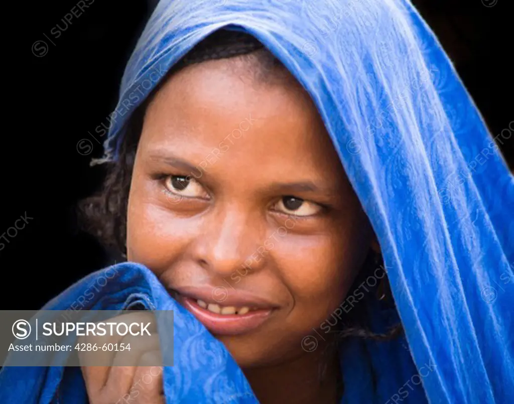 In Ouagadougou, Burkina Faso, a Touareg woman shyly turns her face from the camera.   The Touareg are a nomadic ethnic group that are traditionally pastoralists. NOT MODEL RELEASED. EDITORIAL USE ONLY.