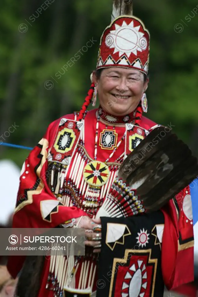 A Native American woman in full traditional regalia parades in the dance circle at the 8th Annual Red Wing PowWow in Virginia Beach, Virginia. NOT MODEL RELEASED. EDITORIAL USE ONLY.