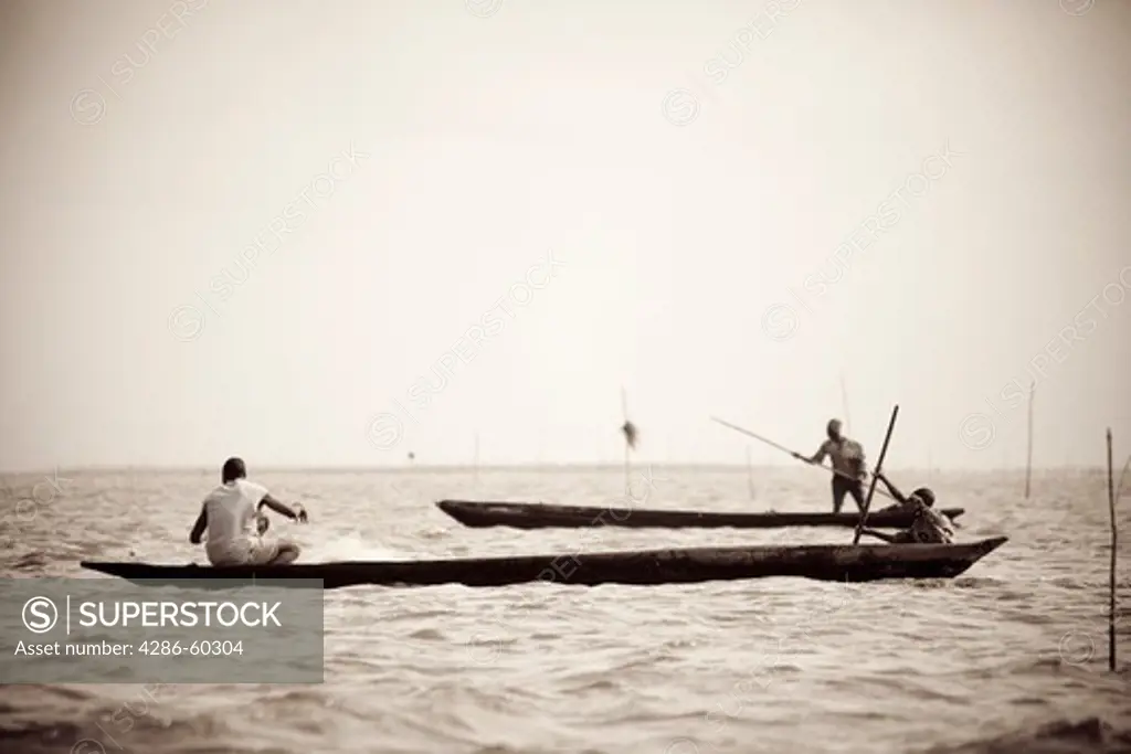 Fishermen ply the waters between Cotonou and Ganvie in Benin. NOT MODEL RELEASED. EDITORIAL USE ONLY.