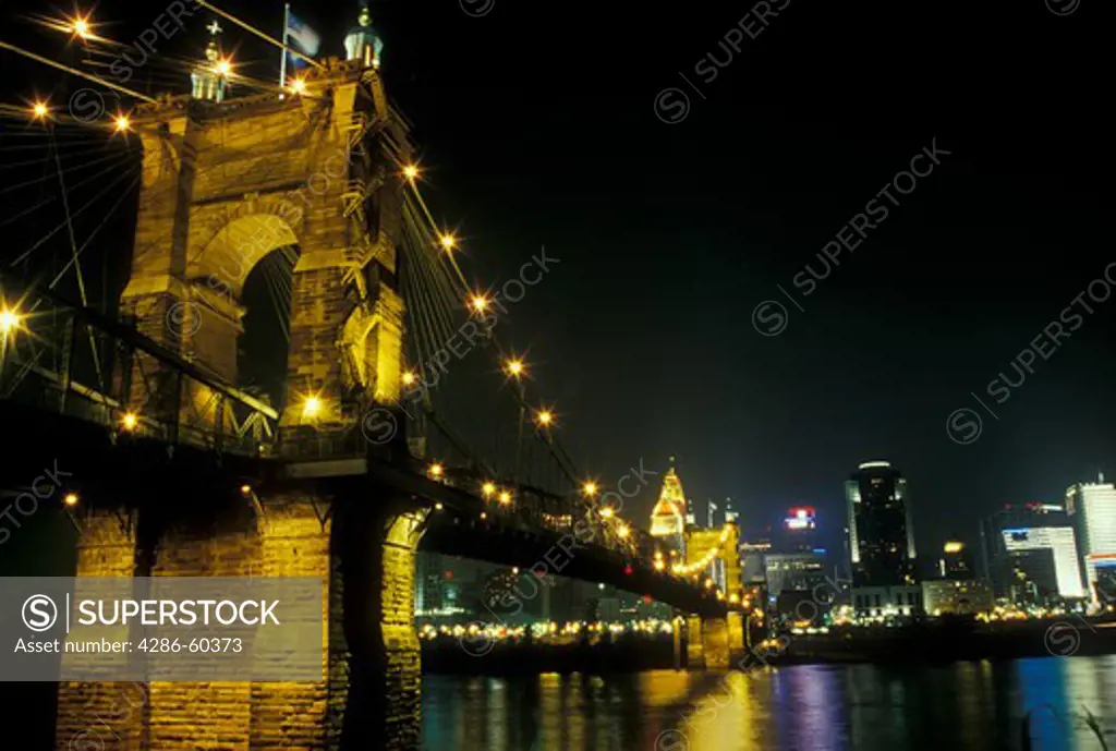 Cincinnati, OH, Ohio, John A. Roebling Bridge, downtown skyline along the Ohio River, evening