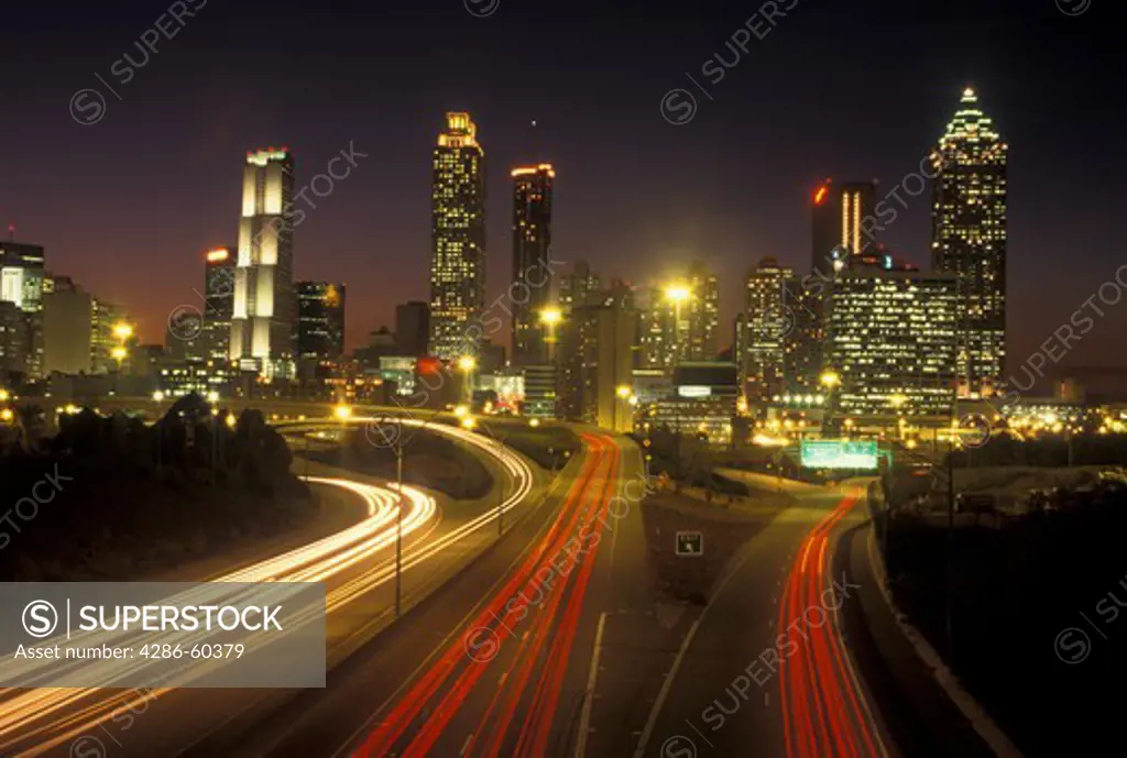 Atlanta, GA, Georgia, Downtown skyline, Freedom Parkway, evening, traffic, streaks of car lights along the expressway, road
