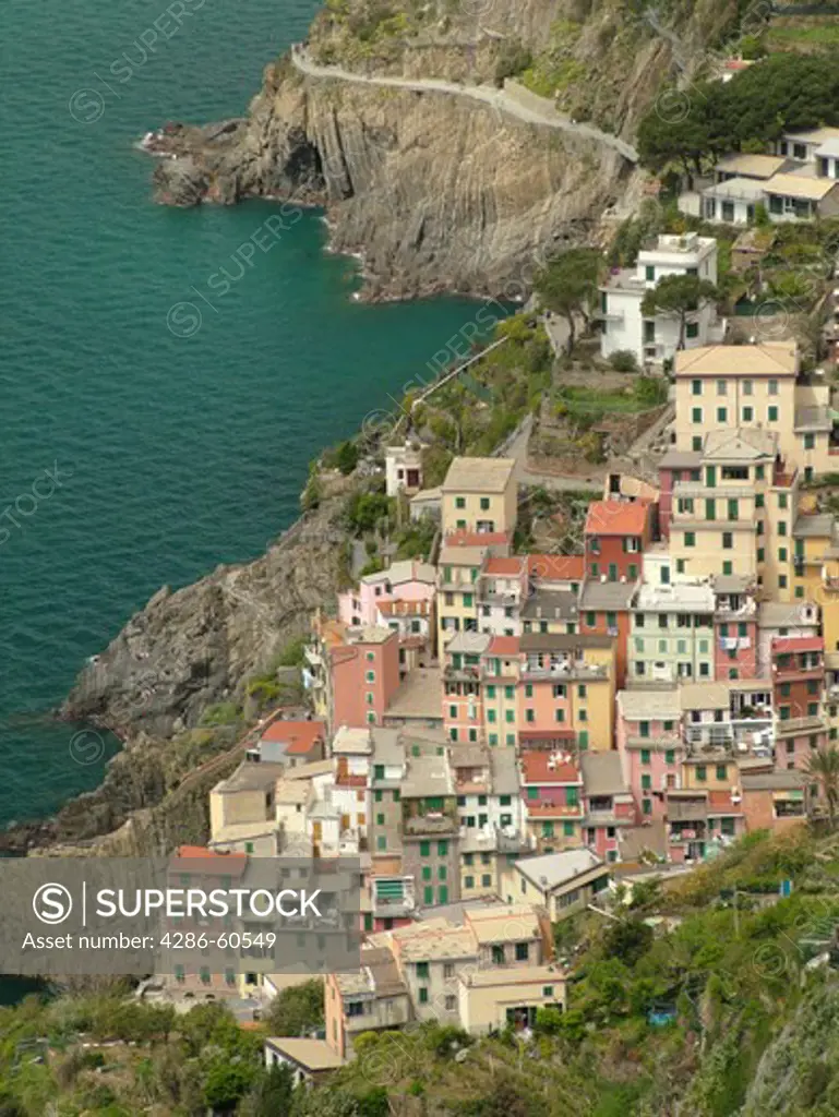 Cinque Terre, Liguria, Italy, Riomaggiore, Riviera di Levante, Ligurian Riviera, Europe, Scenic view of Riomaggiore, a Cinque Terre village, along the steep rocky coastline of the Ligurian Sea.