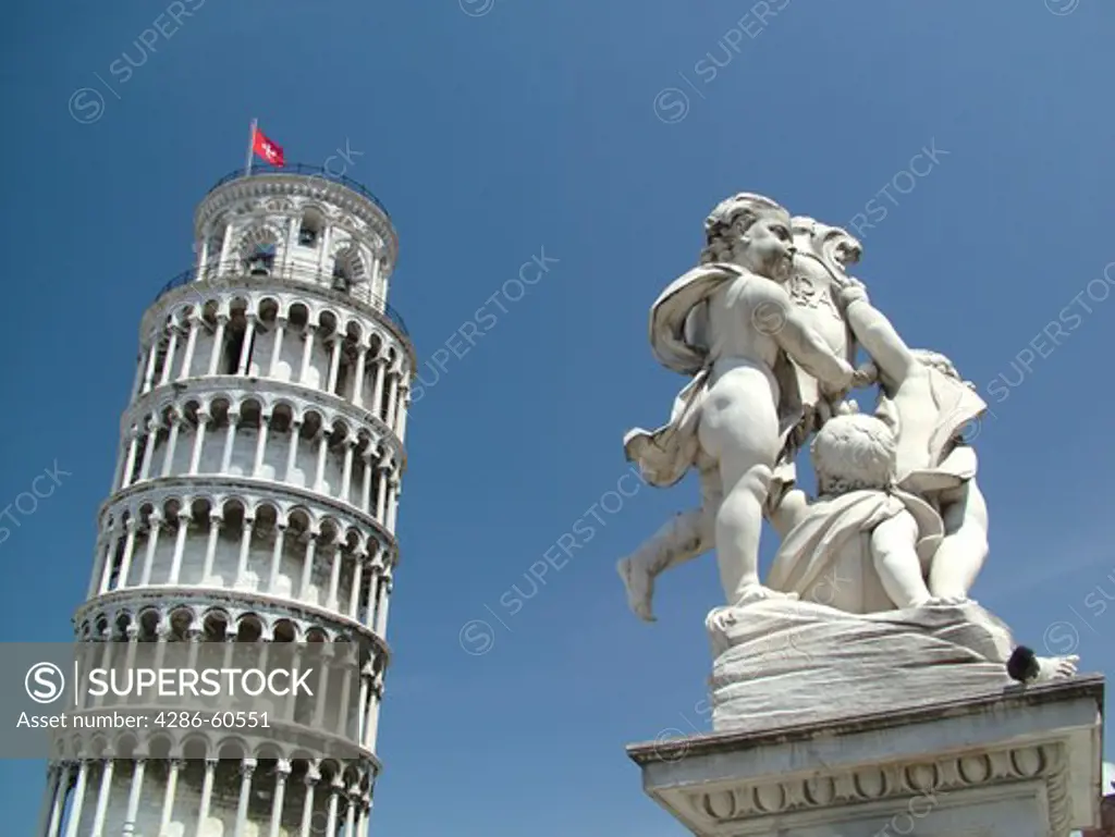 Pisa, Tuscany, Italy, Toscana, Europe, The Leaning Tower of Pisa (Torre Pendente) and Cupid Statue in Campo dei Miracoli (Field of Miracles) in the city of Pisa.