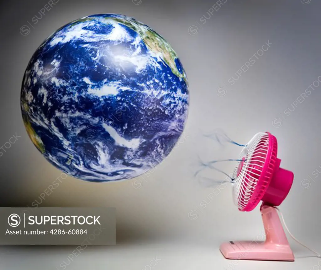 Still shot of a world globe with a pink fan blowing air on it