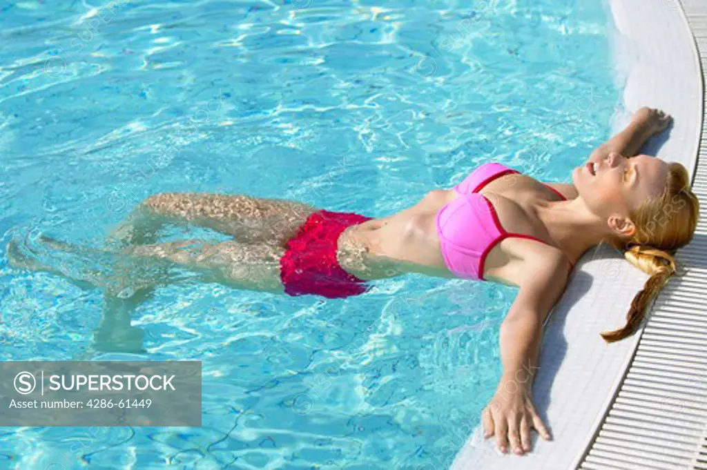 young woman doing acqua gymnastics in the swimming
