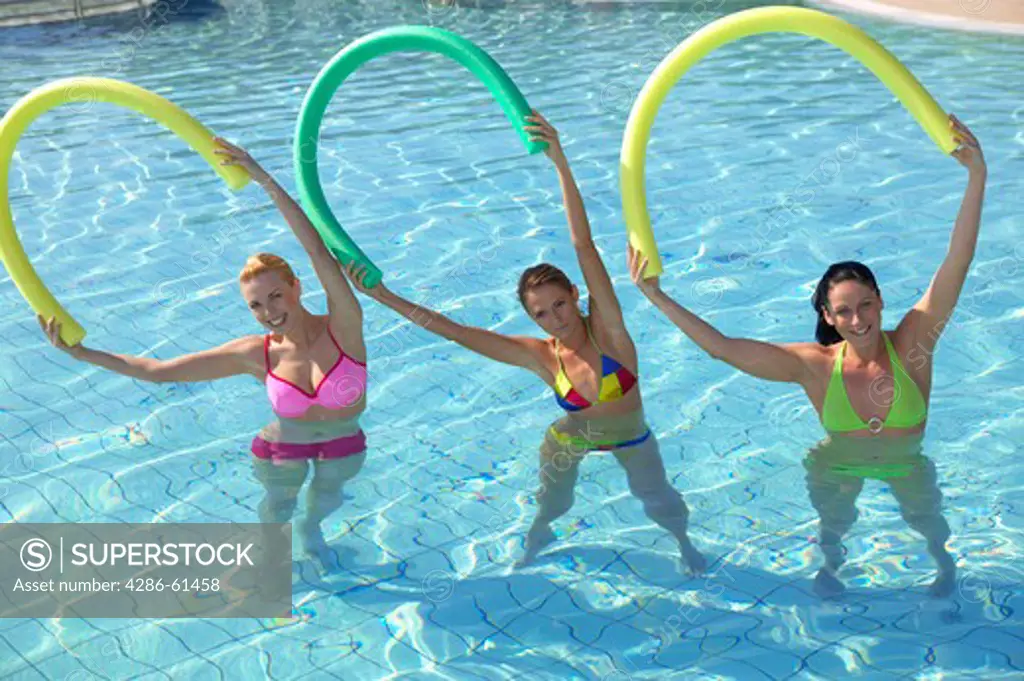 three woman doing aquaaerobic in the swimmingpool