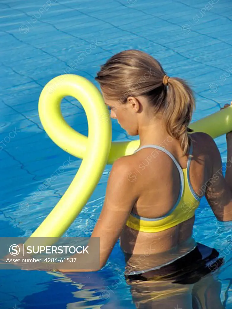 Young woman does Aquaaerobic in the pool