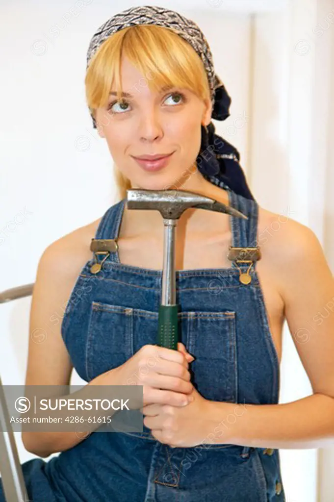 young woman posing with hammer