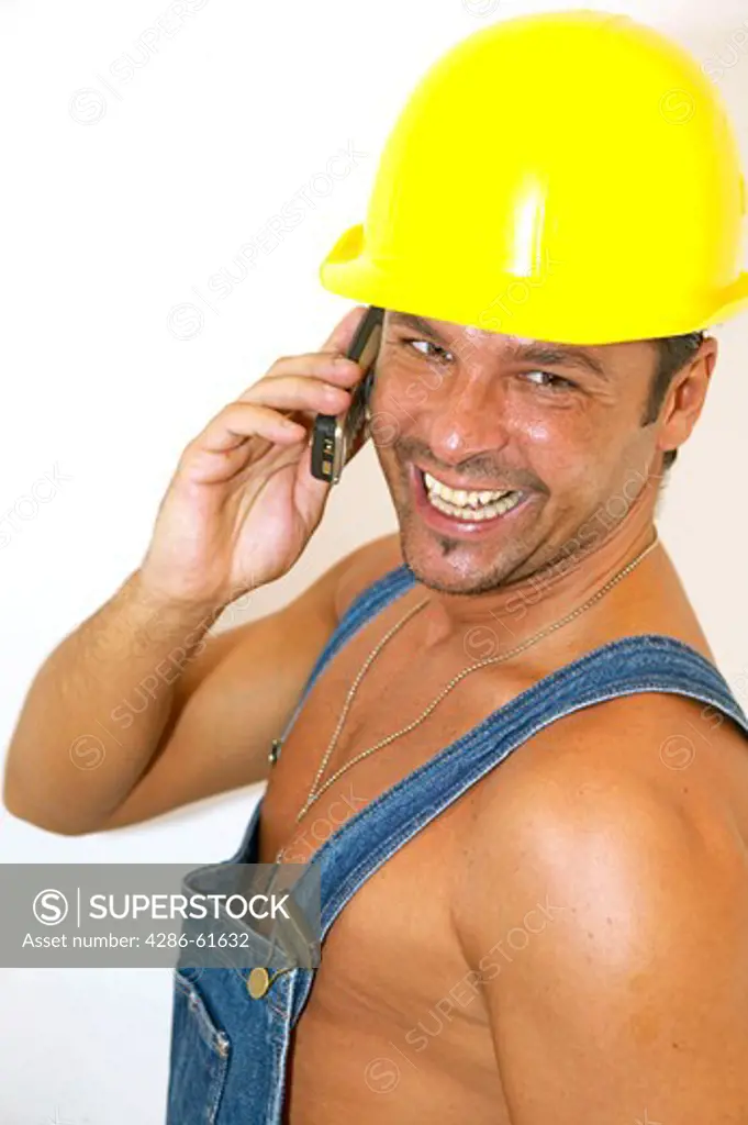 workman with hardhat phoning with mobile