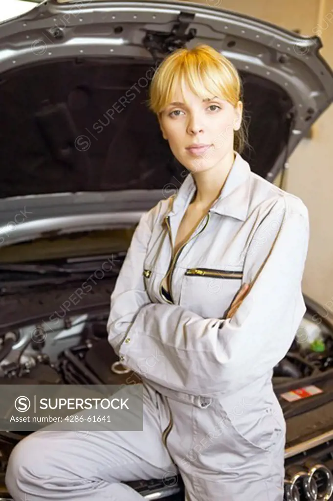 woman  young female motor mechanic at a garage