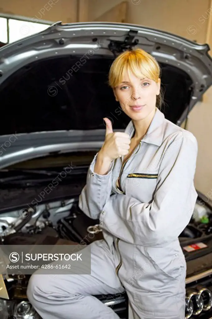 woman  young female motor mechanic at a garage