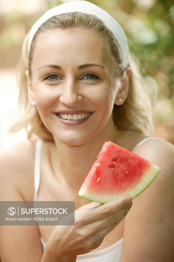 beauty young woman eating melon