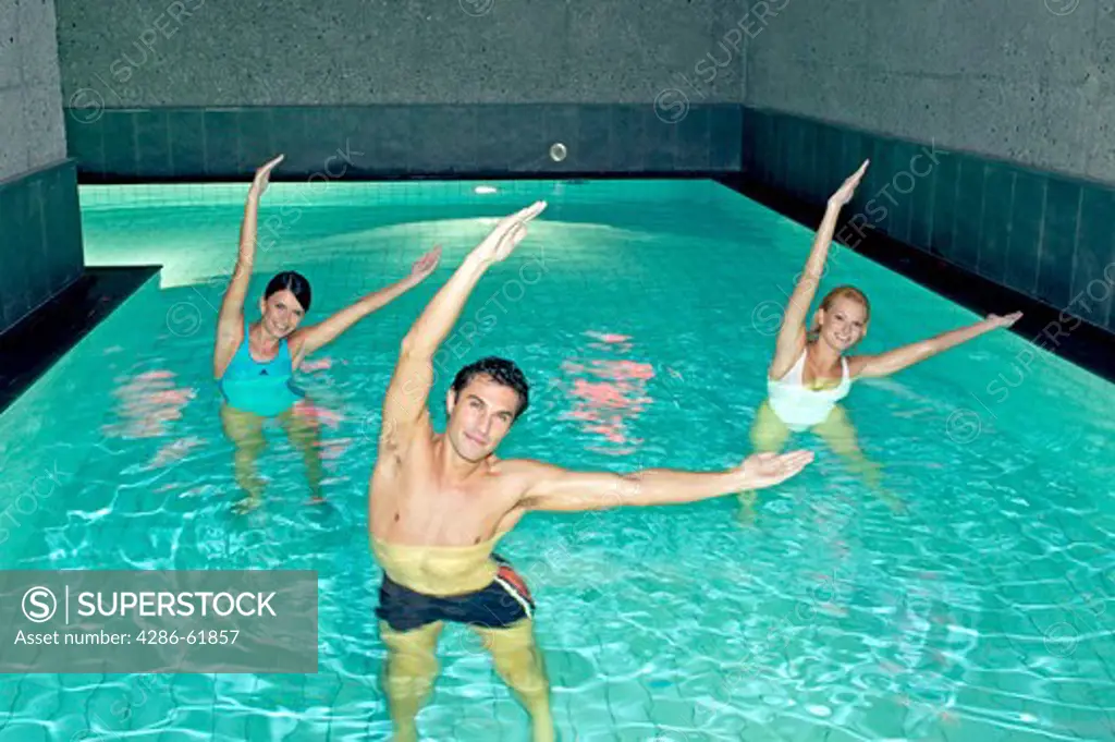 Young people doing aqua aerobics in a pool