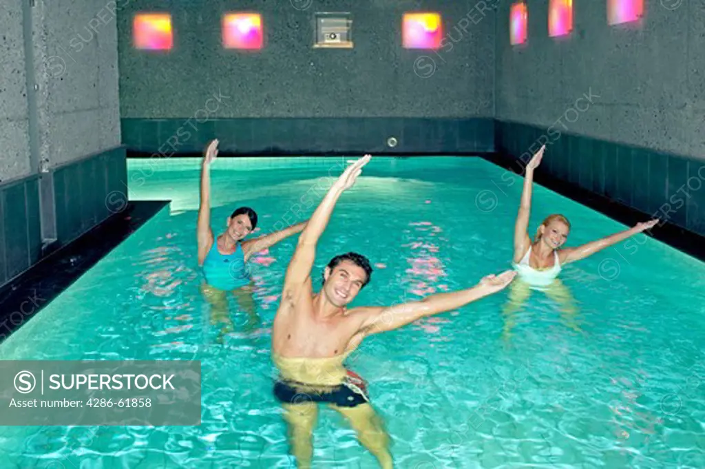 Young people doing aqua aerobics in a pool