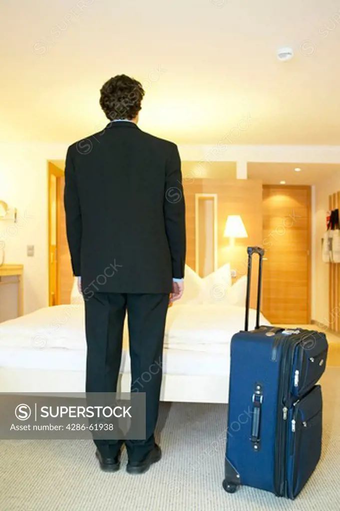 Man at the arrival in his hotel room