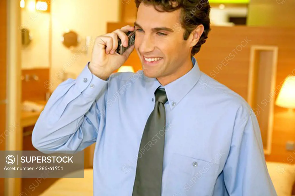 Businessman talking on mobile phone in hotel