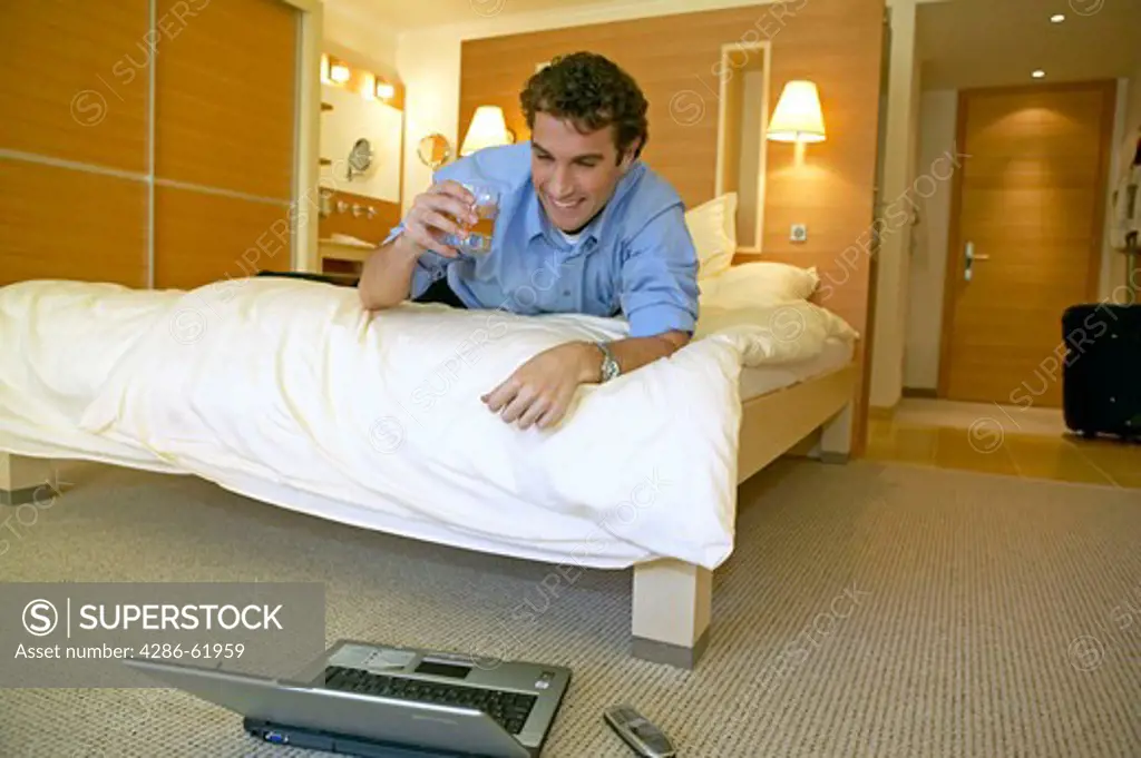 Manager working on a laptop in his hotel room