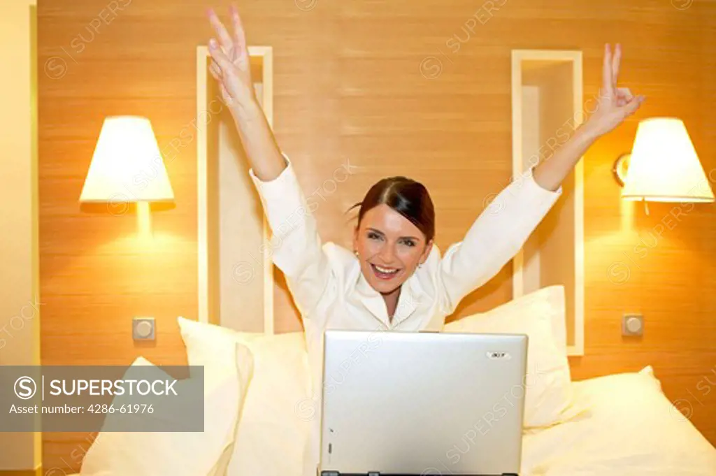 female manager working on a laptop in a hotel room