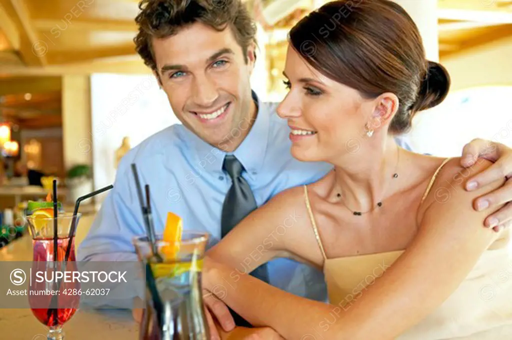 young couple flirting at hotel bar