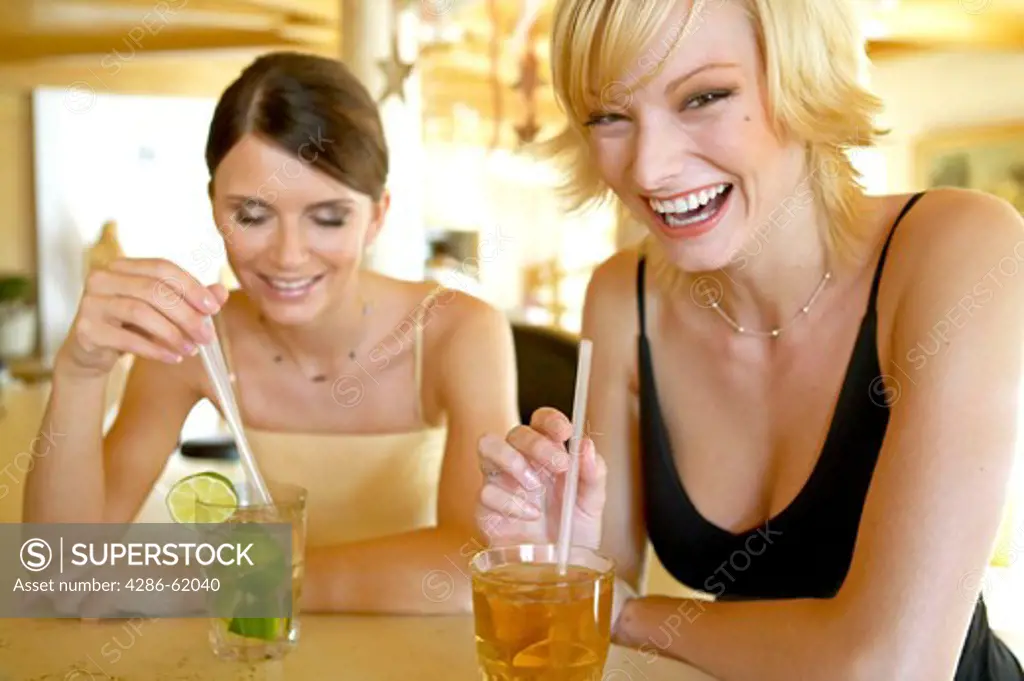 Two women enjoying themselves at a hotel bar