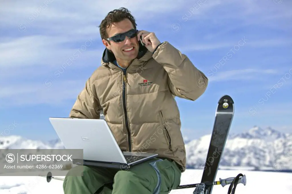man with notebook and mobile at winter holiday