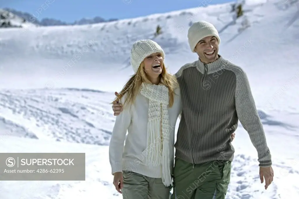 young couple walking in winter landscape