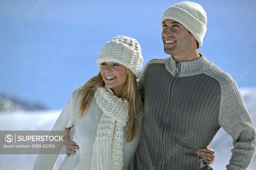 young couple walking in winter landscape