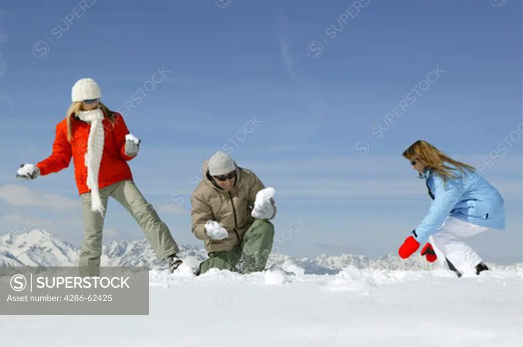 young people having snowball fight fun