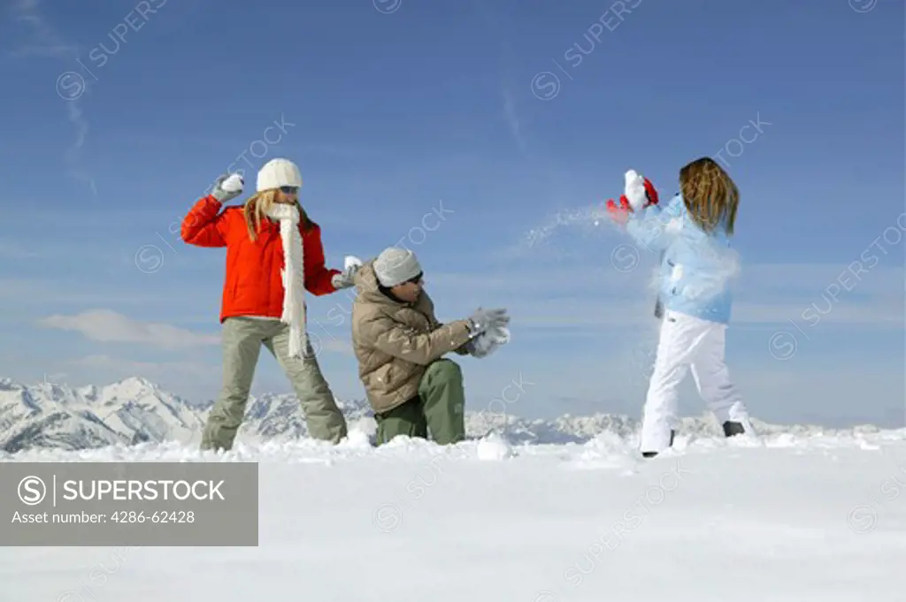 young people having snowball fight fun