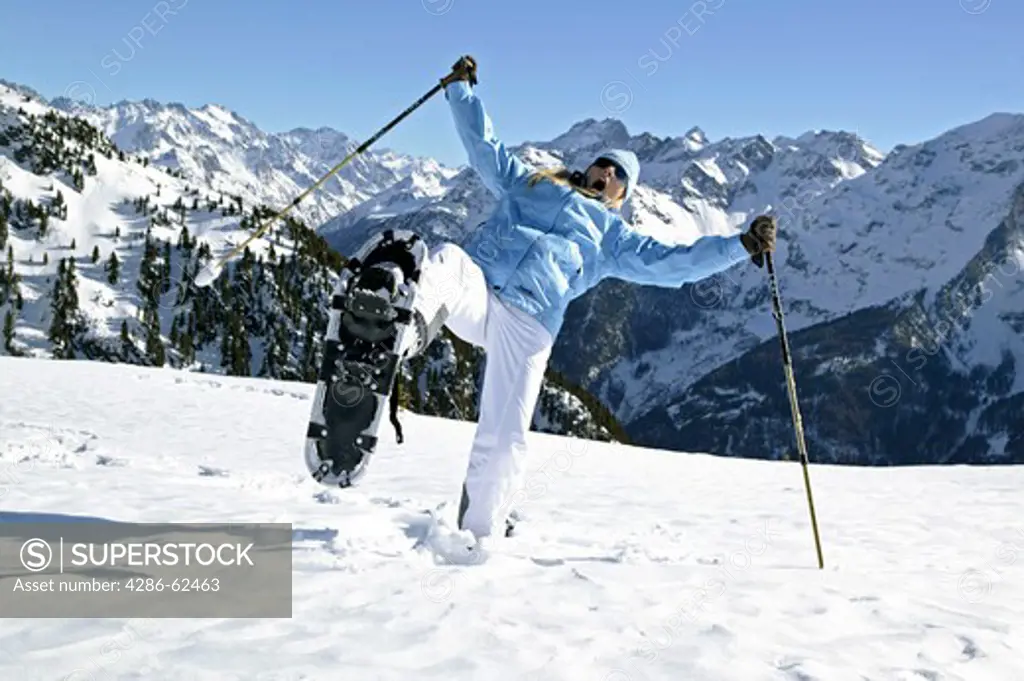 woman in winter hiking with snow shoes