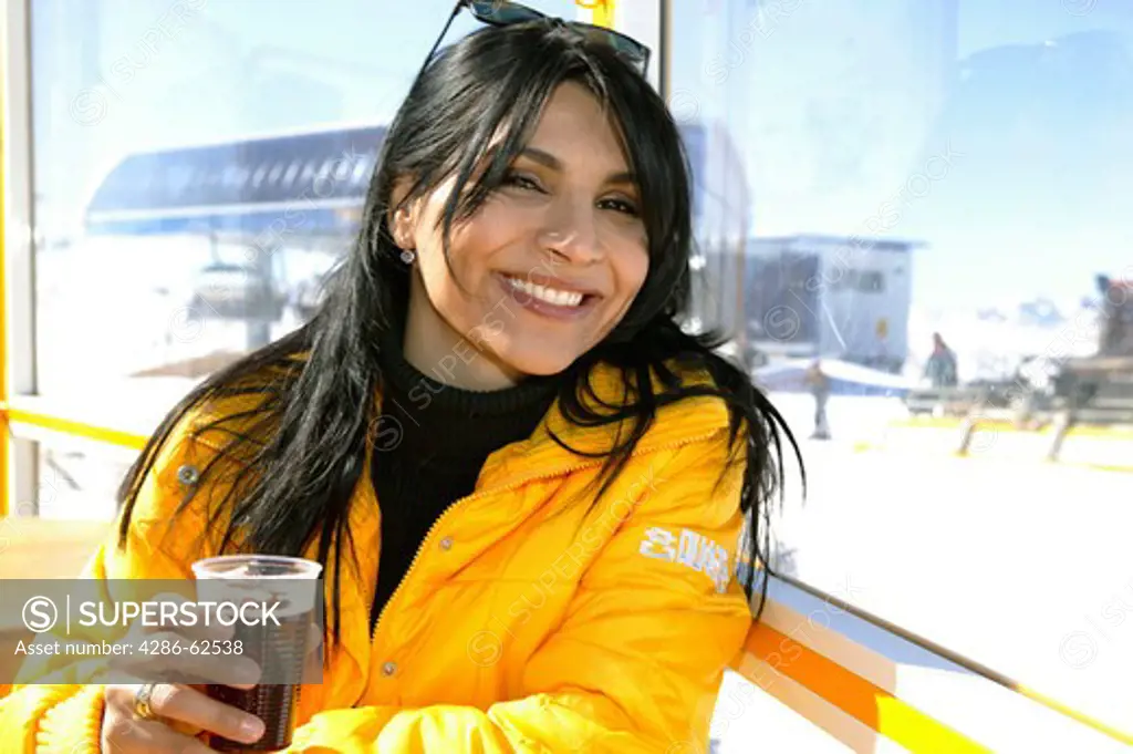 woman drinking mulled wine at a ski bar